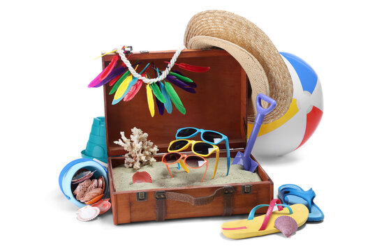 Open suitcase with clothes, beach accessories and shoes isolated on white. Summer vacation