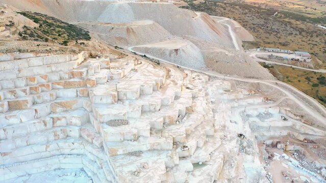 Mining industry: terraces of marble quarries. Marble white mining, close up, aerial view.