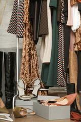 Untidy cluttered woman wardrobe with stylish clothes and accessories. Messy clothes thrown on a...