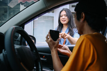 Young woman ordering a commercial taxi driver by smartphone