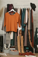 Untidy cluttered woman wardrobe with stylish clothes and accessories. Messy clothes thrown on a...