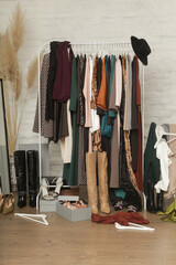 Untidy cluttered woman wardrobe with stylish clothes and accessories. Messy clothes thrown on a...