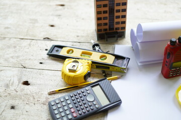 Set of professional construction tools and safety helmet on a work table. Top view. Tools. Various tools on a wooden table. engineering drawing Tools to work beyond architectural blueprints