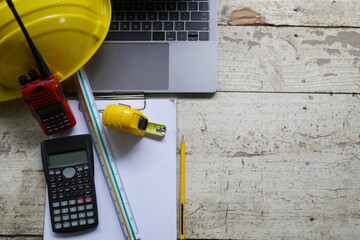 Set of professional construction tools and safety helmet on a work table. Top view. Tools. Various tools on a wooden table. engineering drawing Tools to work beyond architectural blueprints