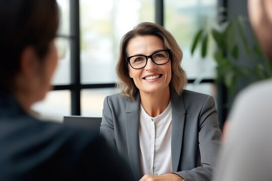 Smiling Mature Middle Aged Financial Advisor Consulting Clients Couple.