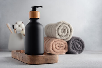 Obraz na płótnie Canvas Black bottle with dispenser pump in minimal home interior