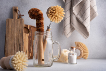 Fototapeta na wymiar Set of bamboo brushes and natural products for dish wash and kitchen cleaning