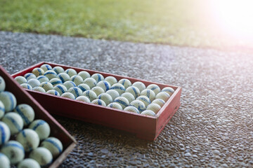 White balls in a red golf box