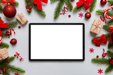 Top view of empty tablet on Christmas background made of new year decorand festive decorations. New year holiday concept. Mockup