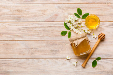 Fototapeta na wymiar honey jar with acacia flowers and leaves. fresh honey top view flat lay