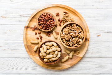 Walnut kernel halves, in a wooden bowl. Close-up, from above on colored background. Healthy eating Walnut concept. Super foods with copy space