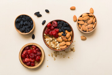 Cooking a wholesome breakfast. Granola with Various dried fruits and nuts in a bowl. The concept of a healthy dessert. Flat lay, top view with copy space
