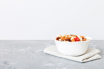 Cooking a wholesome breakfast. Granola with Various dried fruits and nuts in a bowl. The concept of a healthy dessert. Flat lay, top view with copy space