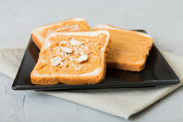 Peanut butter sandwiches or toasts on light table background.Breakfast. Vegetarian food. American cuisine top view vith copy space