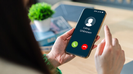 Human use smartphone with incoming call from unknown number, spam, prank caller, hoax person, fake identity, scammer, scam with mobile phone, hacker, call center, crime, call, fraud or phishing 