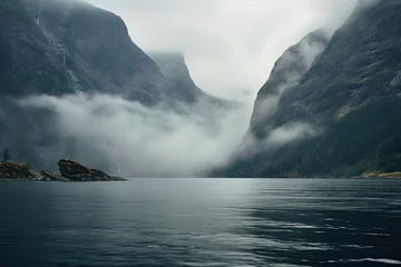 Fototapeten Sea bay or lake and misty fjords landscape. © OleksandrZastrozhnov