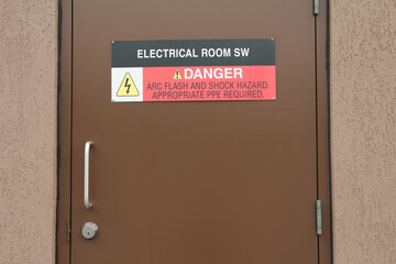 electrical room sw danger arc flash and shock hazard appropriate ppe required sign on brown metal entrance door with handle