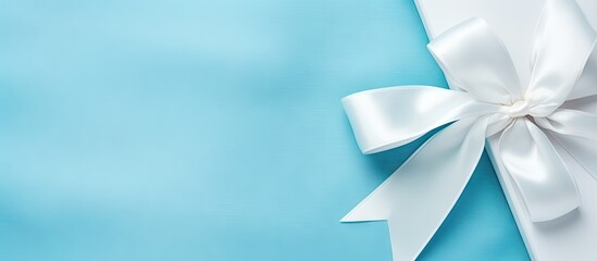 A isolated pastel background Copy space with a blue bow on a white sack - obrazy, fototapety, plakaty