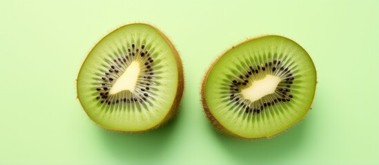 Two halves of a kiwi fruit on a isolated pastel background Copy space