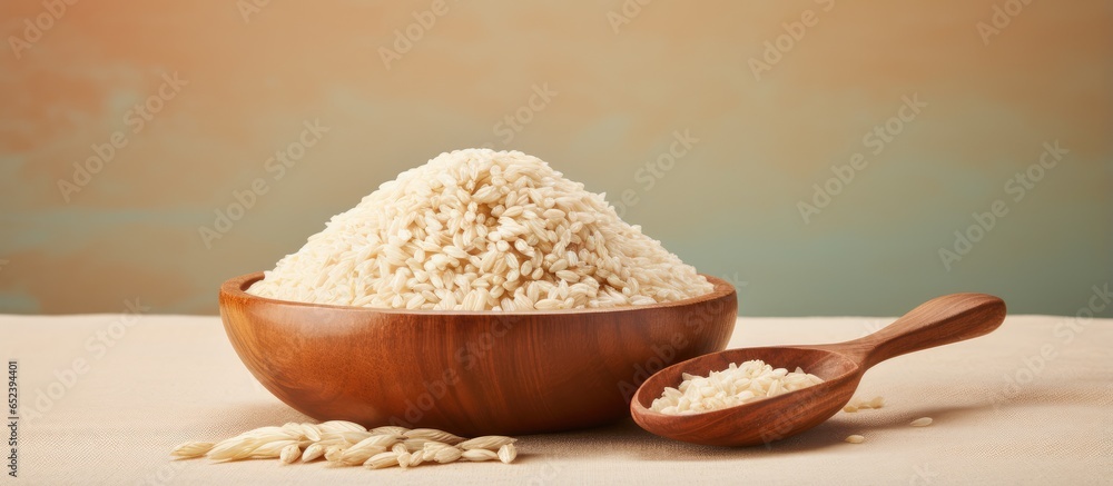 Aufkleber brown rice in wooden bowl on a isolated pastel background copy space front view naturally nutritious