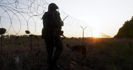 Soldier with service dog picking up trail, patrol state or private zone border at sunset. Security forces control boundary, protect from enemy and invasion