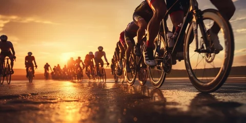 Foto op Plexiglas A group of cyclists at sunset © cherezoff