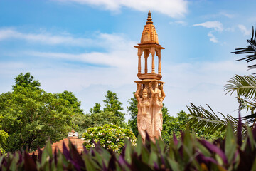 artistic red stone jain god holy pillar at morning from unique angle