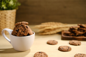 Homemade Chocolate Chip Cookies above Wooden Table, Served with a Bottle of Milk. Bakery Concept with Copy Space for Text