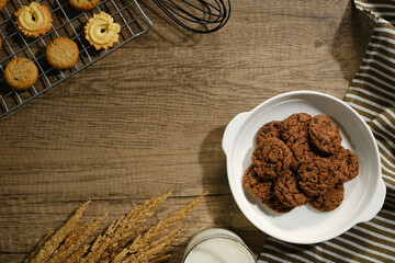 Flat lay composition with chocolate cookies and space for text on wood background