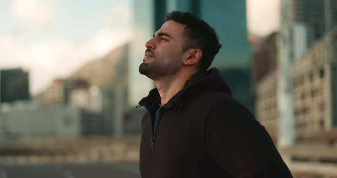 City, fitness and man tired and breathe after urban exercise, outdoor challenge or morning cardio run, endurance or training. Hoodie, breathing and profile of relax person, runner or workout fatigue