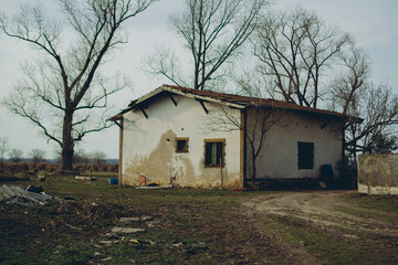 a spooky house abandoned in the countryside in the wintertime