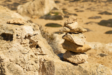 Stones stacked on top of each other with a blurred background.