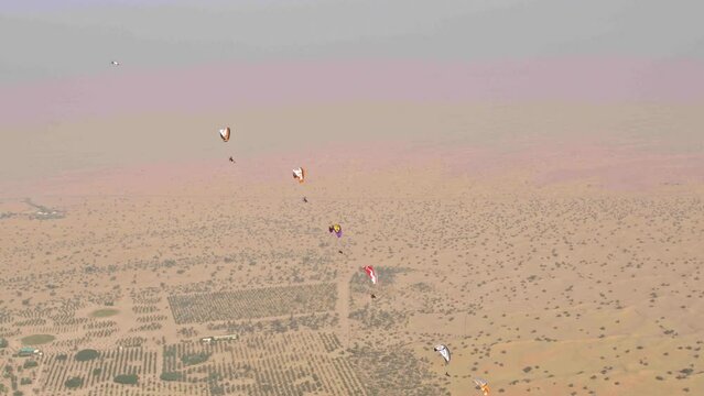 Epic slow motion show of paramotors and glider over desert