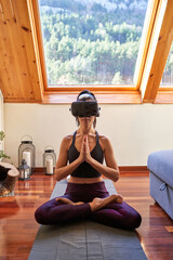 Concentrated woman in VR glasses practicing Lotus asana and nama