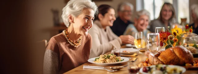 Poster Portrait of a senior woman during Thanksgiving dinner with her family © MP Studio