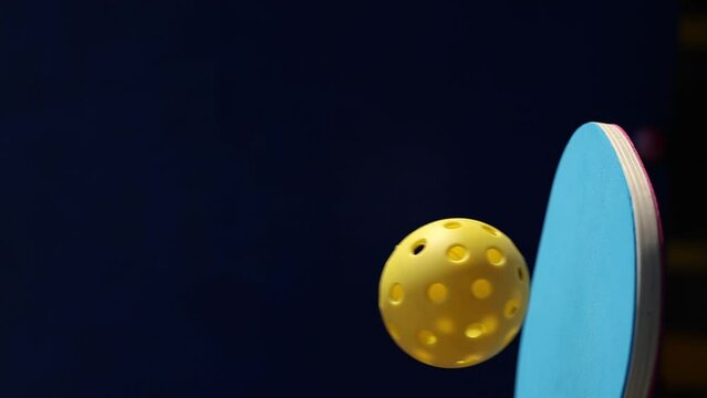 Pickle ball paddle juggling a ball in slow motion