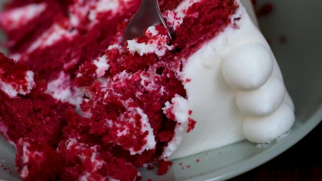 delicious cake red Velvet white airy cream red porous cake layers with fork crush dessert close-up. layers of cake layers of delicious cake pleasure and cooking culinary show study structure of dough