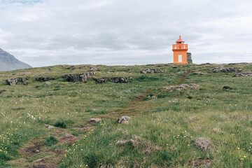 Fototapeta na wymiar Hafnarnesviti orange lighthouse in Iceland, near Bolungarvik Osholaviti