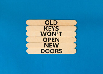 Old keys do not open new doors symbol. Concept words Old keys do not open new doors. Beautiful blue table blue background. Business, popular quotation old key new door concept. Copy space.