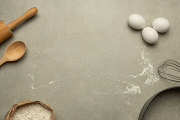 Gray stone background with flour and cooking tools