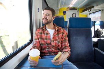 Handsome man sitting on train