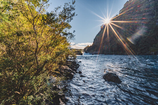 sunset by a wild river in puerto varas in chile