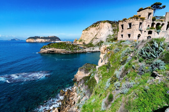 view of Trentaremi bay of Posillipo, a district of Naples, Italy. There is a small empty beach in a cove. The coast overlooks the Mediterranean Sea.