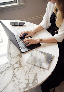 a woman working with her laptop at the table, light gold and black, feminine empowerment, marble, ai generative