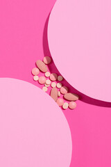 Creative layout with pills on pastel two tone pink art background. Minimal pharmacy medical treatment concept