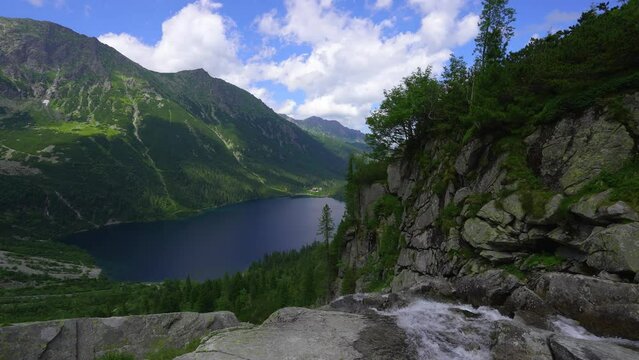 Aerial view of Famous mountains lake morskie oko or sea eye lake at summer day. Beautiful sky sunlight above Tatras lake landscape. UNESCO's World Network of Reserves. Tatra national park, Poland.