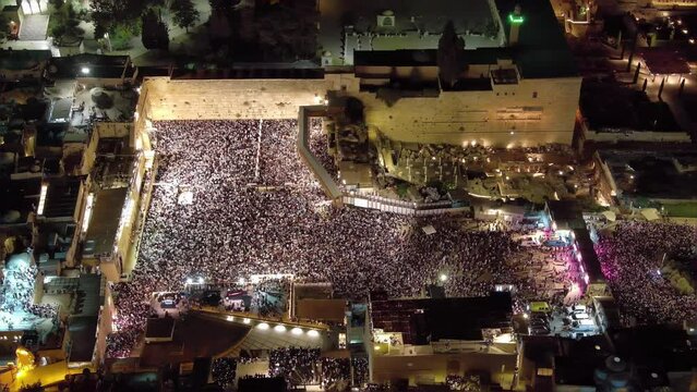 thousnads of jewish prayers at the western wall, aerial night 

Forgiveness Prayers at The Hebrew month of Elul, before yom kipur, drone view, September 2023
