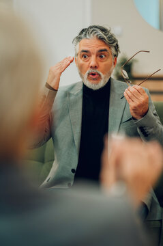 An upset and frustrated mature male client is expressing discontent