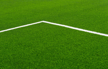 Green synthetic grass sports field with white line shot from above. Soccer, hurling, lacrosse,...