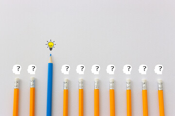 bright light bulb and question mark with pencils concept image 